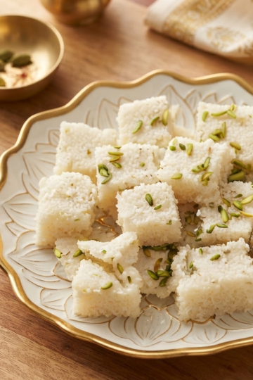Make soft and delicious Coconut Burfi Recipe at home with fresh coconut, milk, sugar, and cardamom. An easy Diwali sweet recipe without mawa.