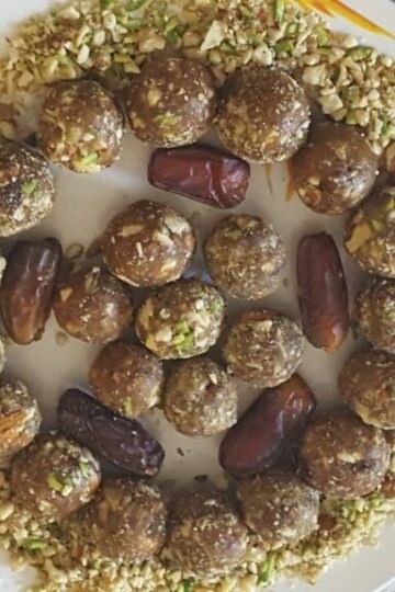Dates and nuts ladoo recipe made with dates, almonds, walnuts, pistachios, and cashews arranged on a serving plate