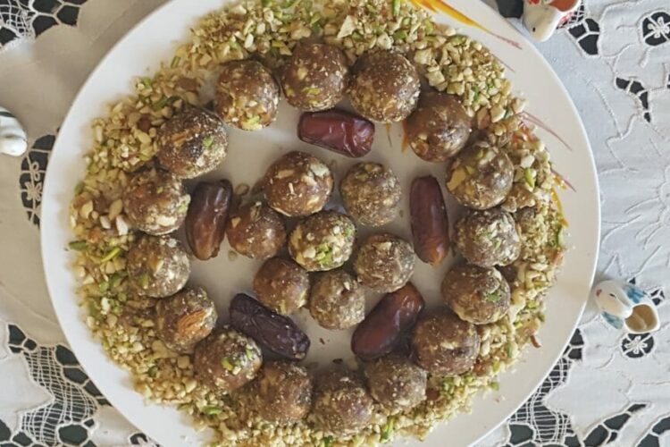 Dates and nuts ladoo recipe made with dates, almonds, walnuts, pistachios, and cashews arranged on a serving plate