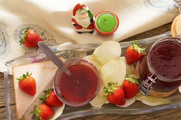 Homemade strawberry jam recipe made with fresh strawberries served in a glass jar with toast