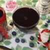 Homemade blueberry syrup recipe made with fresh blueberries, lemon juice, and sugar served in a glass bottle with fresh blueberries