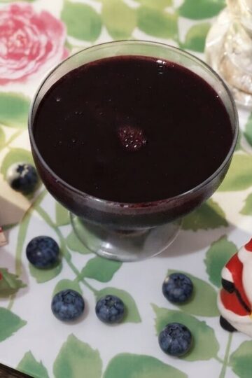 Homemade blueberry syrup recipe made with fresh blueberries, lemon juice, and sugar served in a glass bottle with fresh blueberries