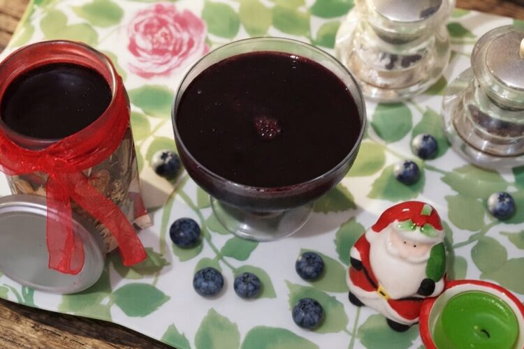Homemade blueberry syrup recipe made with fresh blueberries, lemon juice, and sugar served in a glass bottle with fresh blueberries