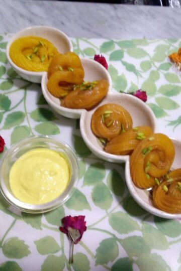Crispy homemade Jalebi Recipe soaked in saffron sugar syrup and served with rabri