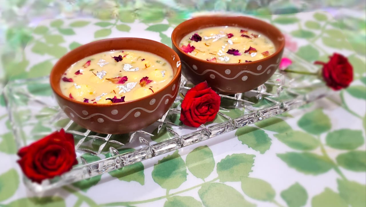 Homemade Angoori Rasbhari, soft and spongy rasgullas made from paneer, soaked in sweet saffron milk, garnished with cardamom and nuts – a fasting-friendly Indian dessert perfect for Navratri.
